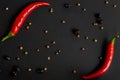 Chili pepper and different spices on a black background. Flat-lay, top view
