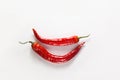 Chili pepper smile. Two whole red chili peppers on white wooden background. Flat lay, top view Royalty Free Stock Photo