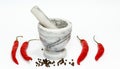 Chili pepper, stone mortar and pestle on white background Royalty Free Stock Photo