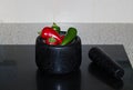 Fresh Raw Chili Peppers In A Stone Mortar & Pestle Royalty Free Stock Photo