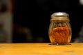 Chili powder bottle with bokeh background Royalty Free Stock Photo