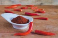 Chili powder and fresh peppers on old wood Royalty Free Stock Photo