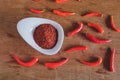 Chili powder and fresh peppers on old wood Royalty Free Stock Photo