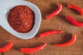 Chili powder and fresh peppers on old wood table Royalty Free Stock Photo