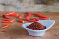Chili powder and fresh peppers on old wood table Royalty Free Stock Photo