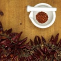 Chili powder in mortar with chillies, close-up Royalty Free Stock Photo
