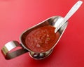 Chili tomato sauce on a red Royalty Free Stock Photo