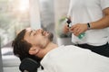 Chill brunette guy laying down in barbershop chair Royalty Free Stock Photo
