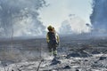 Firefighter walks through the ashes of the fire Royalty Free Stock Photo