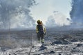 Firefighter walks through the ashes of the fire