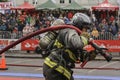 Professional firefighter drags the hose