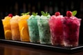 Chilled delight, row of icy fruit slushies, each in a plastic cup Royalty Free Stock Photo