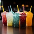 Chilled delight, row of icy fruit slushies, each in a plastic cup Royalty Free Stock Photo