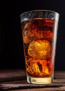 Chilled glass of cola drink with ice cubes isolated on dark background Royalty Free Stock Photo