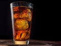 Chilled glass of cola drink with ice cubes isolated on dark background Royalty Free Stock Photo