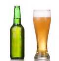 Chilled green bottle with condensate and a glass of beer Royalty Free Stock Photo