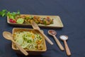 Chilli chicken and noodles served on wooden plates with spoon and fork. delicious chinese food for copy space background Royalty Free Stock Photo