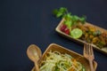 chilli chicken and noodles served on wooden plates with spoon and fork. delicious chinese food for copy space background. shallow Royalty Free Stock Photo