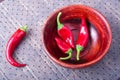 Chilli hot red pepper in a brown wooden bowl Royalty Free Stock Photo