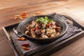 Chilli Spicy Frog Pot served dish isolated on wooden table top view of Hong Kong food