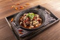 Chilli Spicy Frog Pot served dish isolated on wooden table top view of Hong Kong food