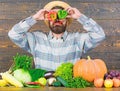 Chilli and sweet pepper as smile and eyes. Bearded farmer hold peppers in front of face. Pepper harvest concept. Farmer