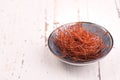 Chilli threads in a bowl on a white shabby background Royalty Free Stock Photo