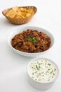 Chilli, tortillas, and sour cream on white Royalty Free Stock Photo