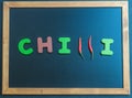 Chilli wooden word on black board