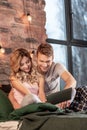 Beaming couple spending first night in their new apartment chilling in bed Royalty Free Stock Photo