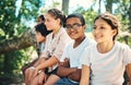 Chilling with the summer camp crew. a group of teenagers sitting on a tree trunk at summer camp.