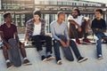 Chilling at the top where we belong. Full length shot of a group of young skaters sitting together on a ramp at a