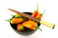 Chillis in a Black Bowl with Chopsticks Royalty Free Stock Photo