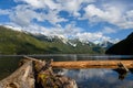 Chilliwack Lake with dead fallen tree trunks and driftwood in the foreground and the reflecting Mount Redoubt Skagit Range Royalty Free Stock Photo