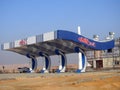 Chillout gas and oil station that is under construction with a blue sky, a construction site of a petrol gas station