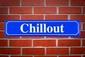 Chillout street sign on brick wall