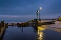 A chilly & wet start at Whitley Bay Promenade, with the railings and street lights reflecting on the wet pavements Royalty Free Stock Photo