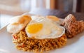 Chilly fried rice with sunny side egg up on white plate. Traditional indonesia and asian food