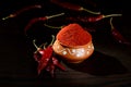 Chilly powder in clay pot with red chilly, dried chillies on wooden background Royalty Free Stock Photo