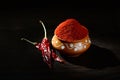 Chilly powder in clay pot with red chilly, dried chillies on wooden background Royalty Free Stock Photo