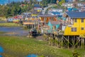 CHILOE, CHILE - SEPTEMBER, 27, 2018: Boat close to a houses on stilts palafitos in Castro, Chiloe Island, Patagonia Royalty Free Stock Photo