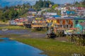 CHILOE, CHILE - SEPTEMBER, 27, 2018: Boat close to a houses on stilts palafitos in Castro, Chiloe Island, Patagonia Royalty Free Stock Photo