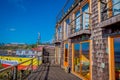 CHILOE, CHILE - SEPTEMBER, 27, 2018: View of beautiful colorful wooden restaurant cebiche on stilts palafitos, in a low Royalty Free Stock Photo