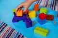 Chils playing with construction toy blocks building a tower in a sunny kindergarten room. Kids playing. creative games Royalty Free Stock Photo