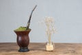 Chimarrao cuia next to a flower vase Royalty Free Stock Photo