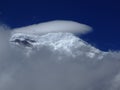 Chimborazo mountain tops covered in snow and surrounded with clouds under the blue sky Royalty Free Stock Photo