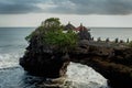 Chimeric temple on the water. Water temple in Bali. Indonesia nature landscape. Famous Bali landmark. Splashing waves