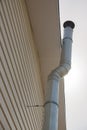 Chimney along the wall of a country house covered with siding, bottom view, Royalty Free Stock Photo