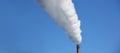 Chimney blows white smoke into blue sky Royalty Free Stock Photo