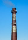 Chimney of a boiler room with installed equipment of a cellular communication station